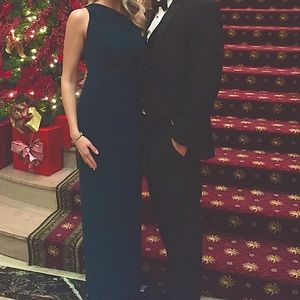 Emerald green, one shoulder floor length dress with jeweled brooch.